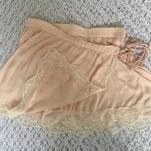 Free People baby pink wrap skirt with cream lace trim! Size medium.